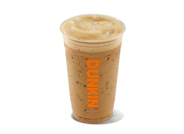 Cup of Dunkin' iced cappuccino on white background