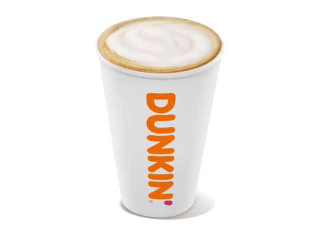 Cup of Dunkin' cappuccino on white background