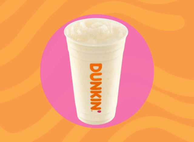 cup of Dunkin' Coolatta on pink and orange background