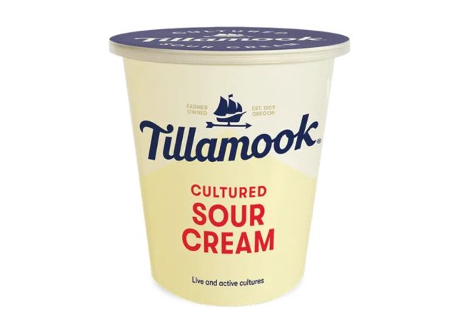 container of sour cream on a white background