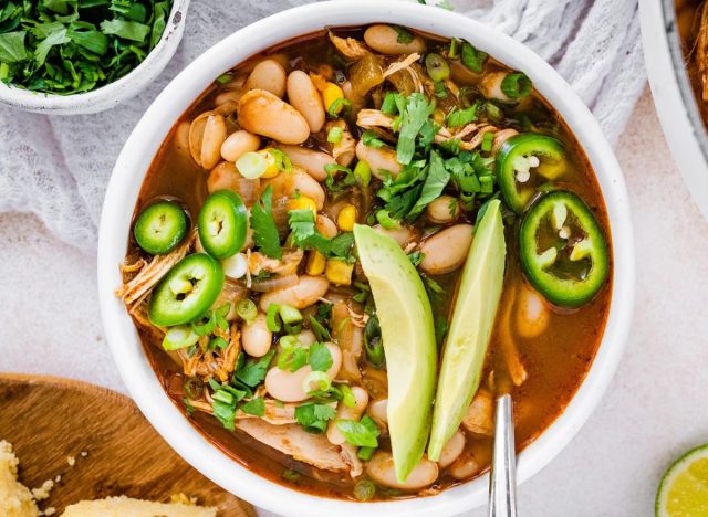 bowl of white bean chili with jalapeños and avocado