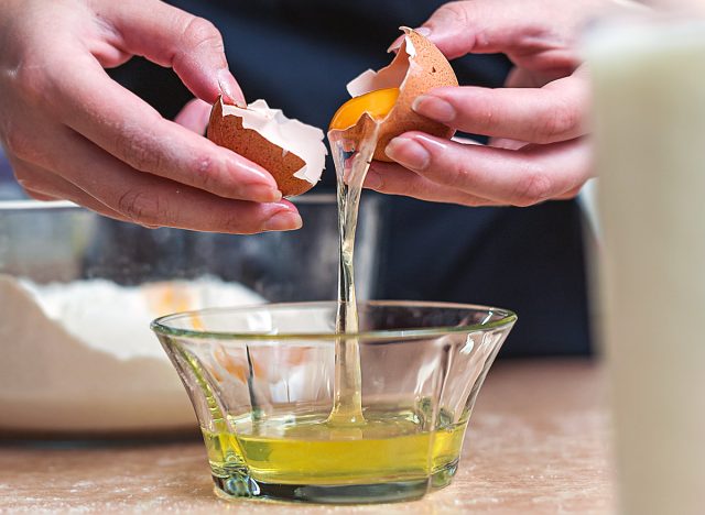 man separating egg whites from egg yolks