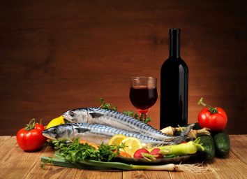 Atlantic Diet concept, fresh fish with wine and veggies