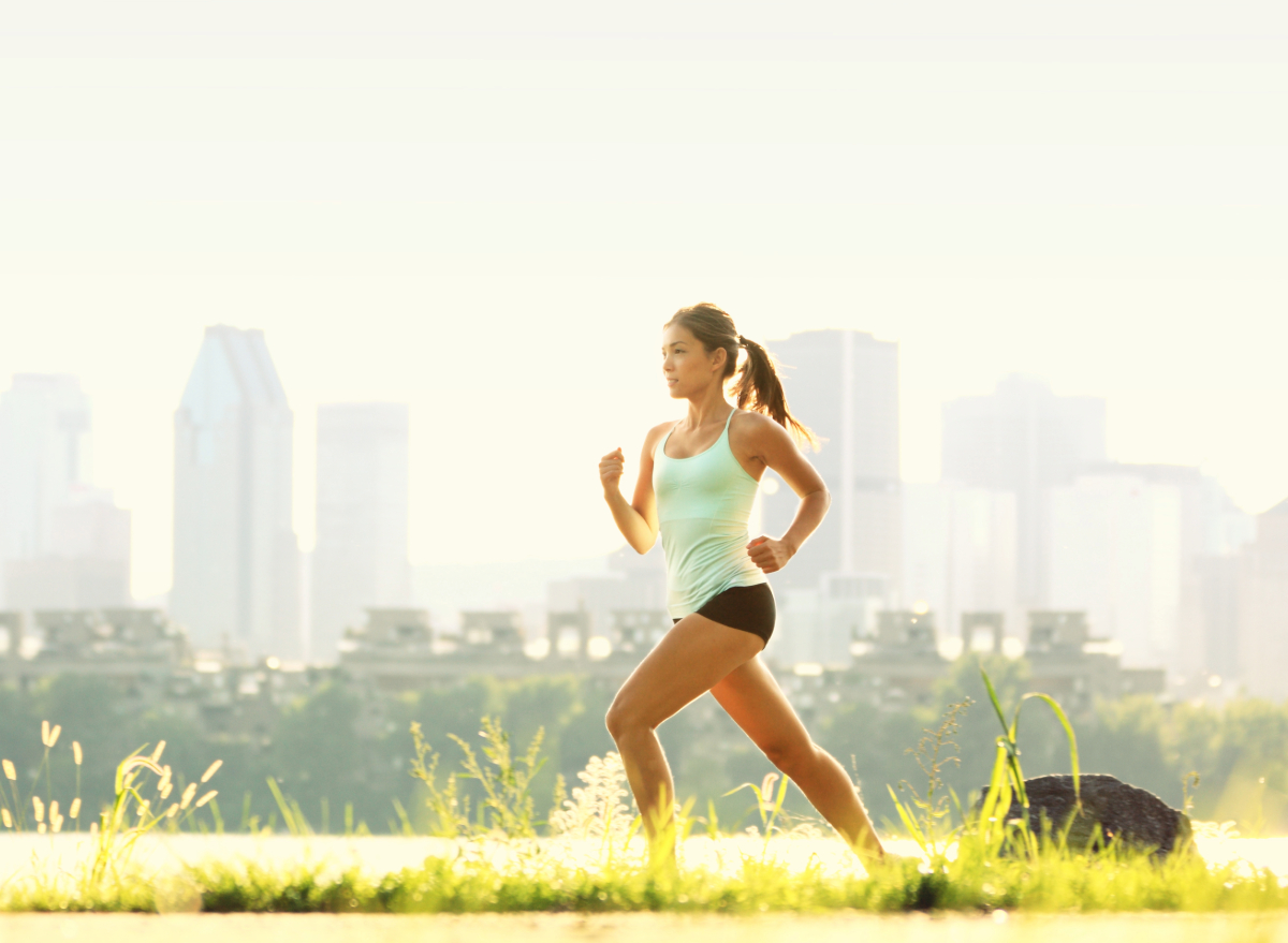 fit woman running outdoors in sunny park, concept of easiest exercises for weight loss