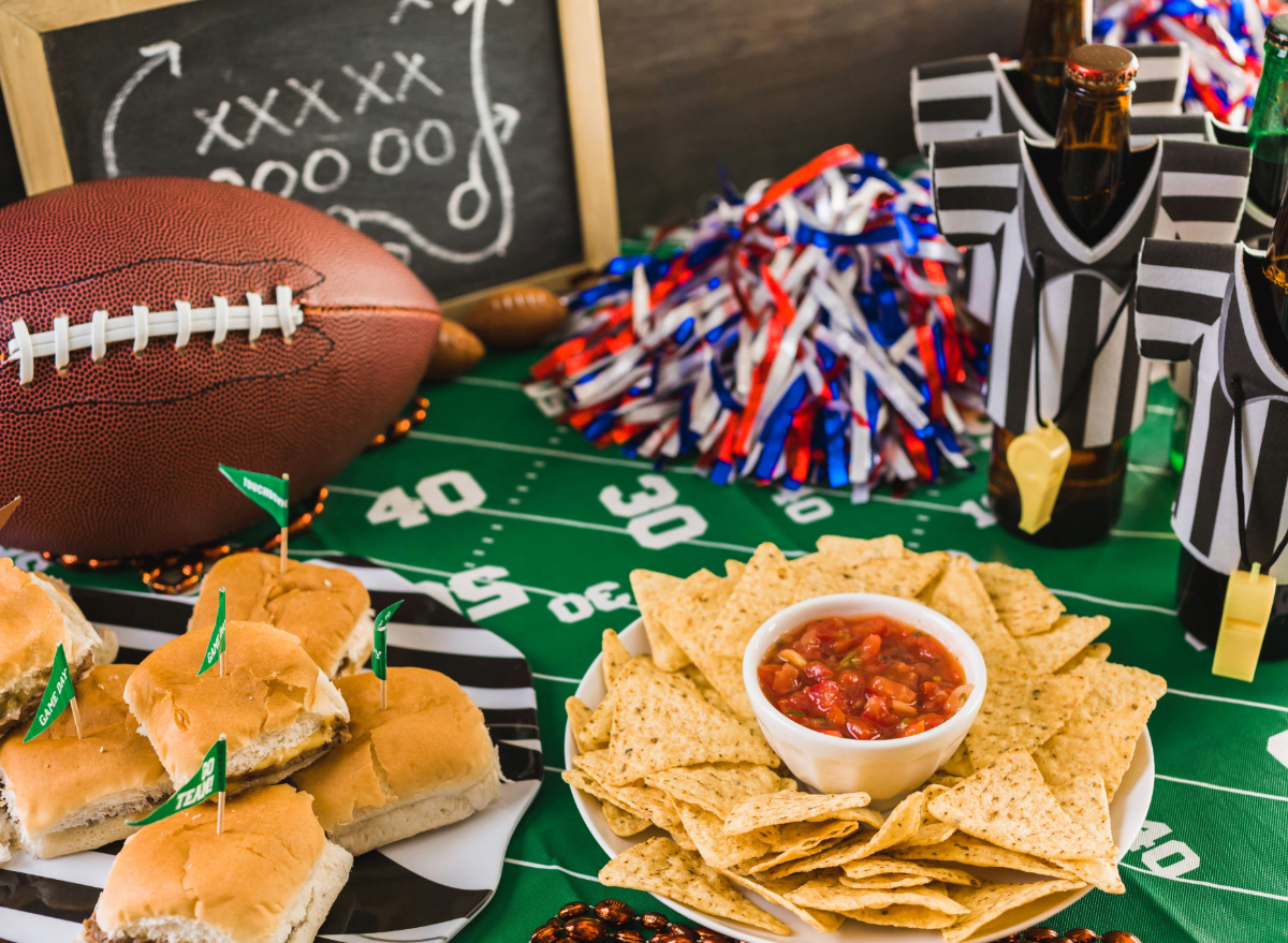 football game day table with beer, chips, salsa, and burgers