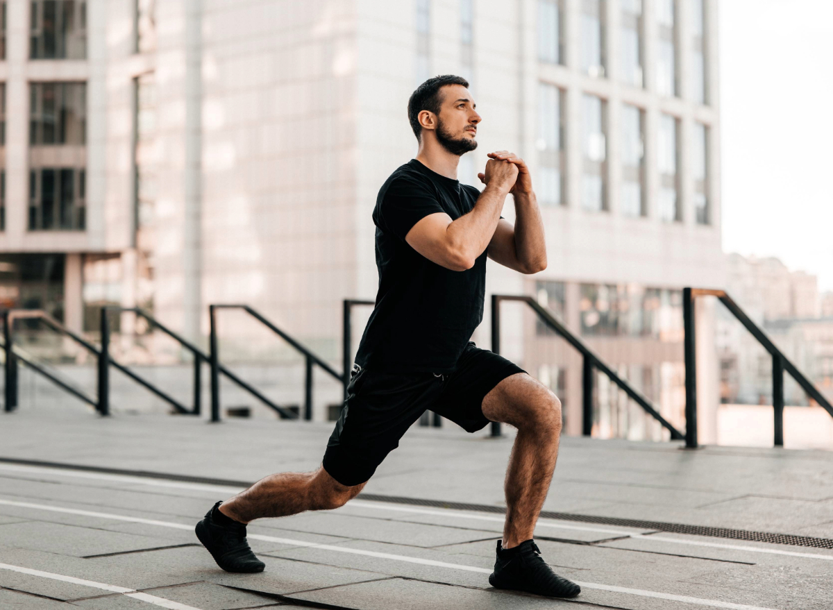 fit man doing walking lunges, concept of no-equipment workout for men to gain muscle and strength