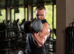 man dumbbell bicep curl, concept of strength workouts for men to build bigger arms