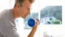 mature man lifting dumbbell, concept of weight-training exercises to do as you age