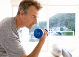 mature man lifting dumbbell, concept of weight-training exercises to do as you age