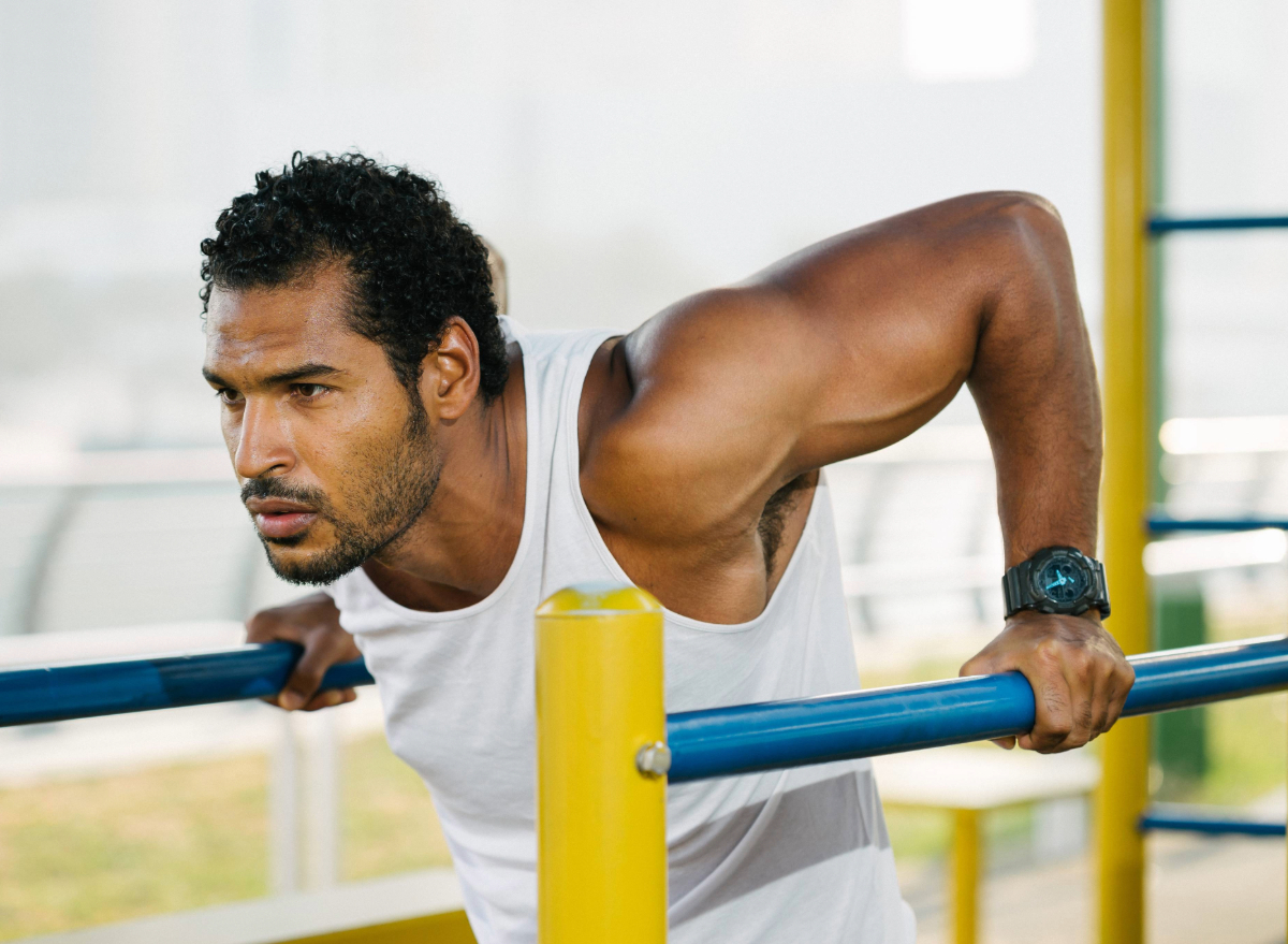 fit man doing tricep dips, concept of strength workouts to regain muscle