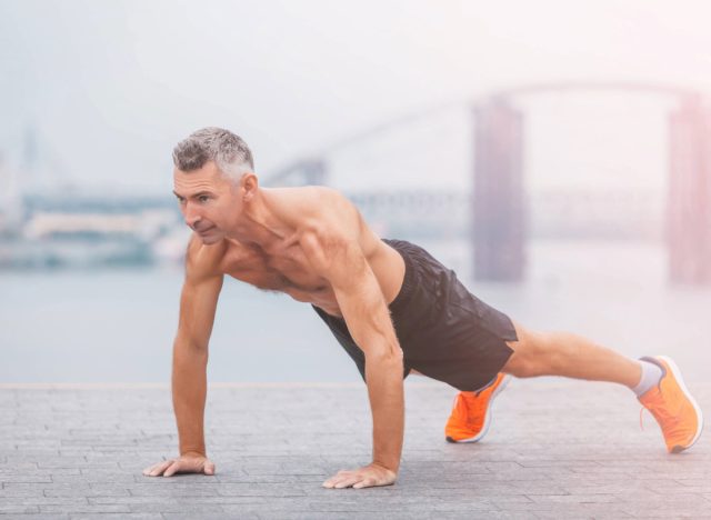 mature, fit man doing planks or pushups, concept of tips to boost muscle growth after 50