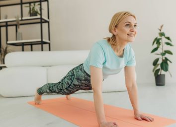 mature woman doing planks, pushups, or burpees, concept of exercises for seniors to do at home