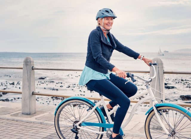 mature woman riding bike, concept of tips to stay active as you age