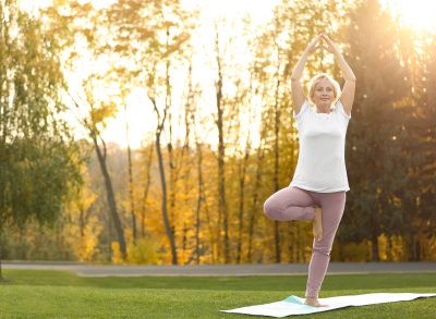 mature woman doing tree pose