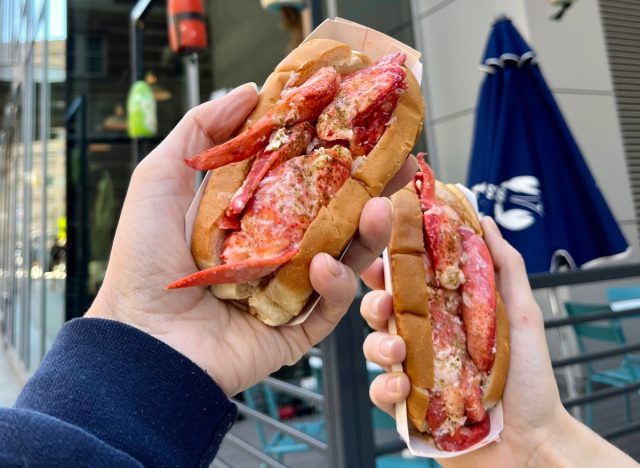 people holding luke's lobster rolls