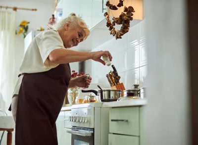 mature woman making soup in kitchen, concept of what world's longest living family eats every day