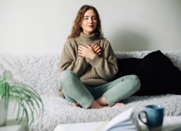 woman breathing exercise on couch, concept of 4-7-8 breathing technique