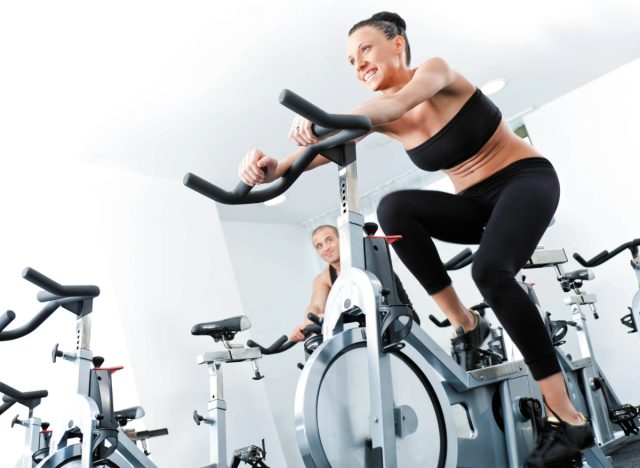 woman cycling in the gym, concept of conditioning exercises to do after 40