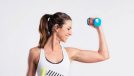 fitness woman lifting dumbbells, concept of dumbbell workouts for flabby arms