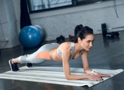 fitness woman doing planks, concept of low-impact exercises for love handles