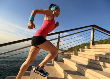 woman doing stair sprints outdoors, concept of high-intensity cardio exercises for weight loss