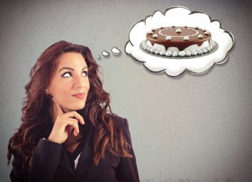 woman thinking of cake, concept of food noise