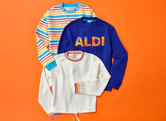 Multi-colored long-sleeved pullover shirts with Aldi branding on an orange background