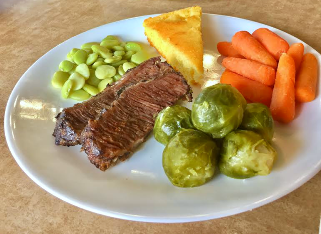 Brussels sprouts on a plate with meat and other veggies at a Golden Corral restaurant