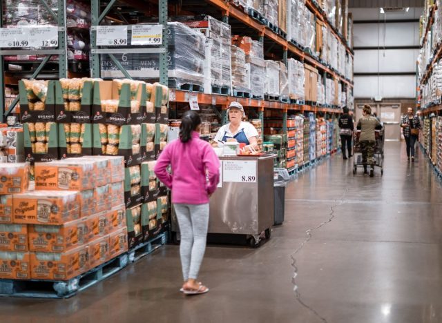 Costco free sample worker serving a customer