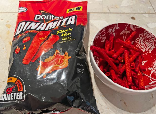 doritos dinamita flamin' hot queso chips in a bag and a bowl.