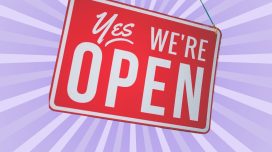 red "yes we're open sign" on lavender background