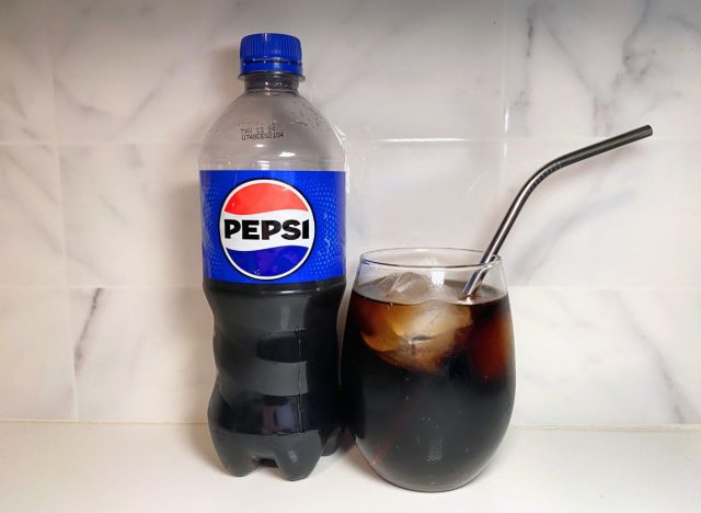 Pepsi bottle next to soda glass