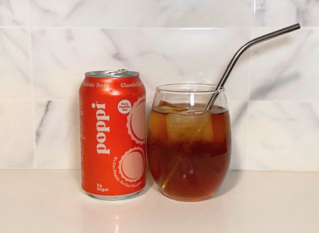 Poppi Classic Cola next to soda glass