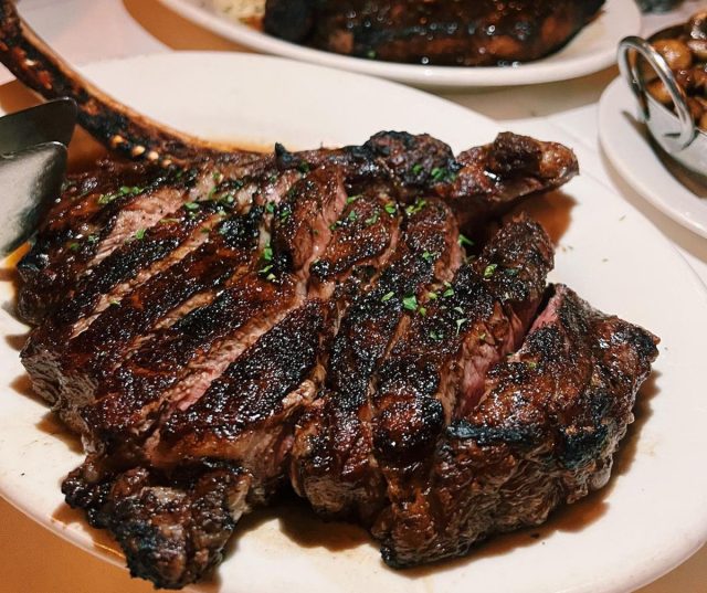 Bone-in ribeye sliced and neatly plated at Morton's the Steakhouse