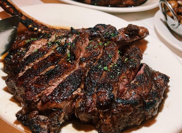 Bone-in ribeye sliced and neatly plated at Morton's the Steakhouse