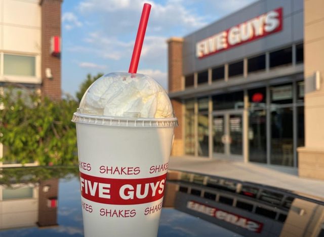 Milkshake with straw outside a Five Guys restaurant