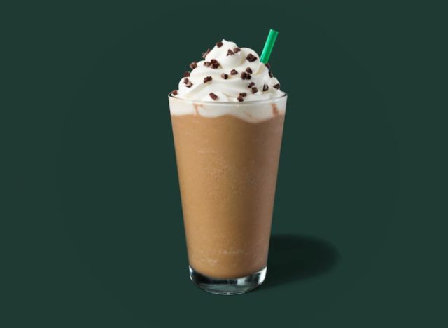 glass of Starbucks Frappuccino on a green background