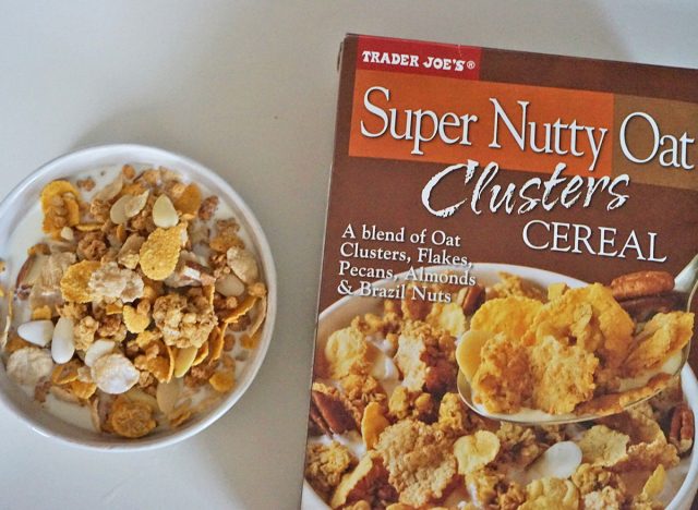 trader joe's super nutty oat clusters cereal box and bowl.
