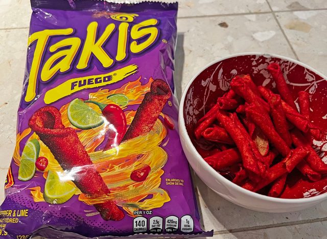 takis fuego rolled tortilla chips in a bag and a bowl.