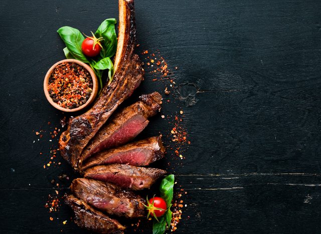 tomahawk steak On a black wooden background