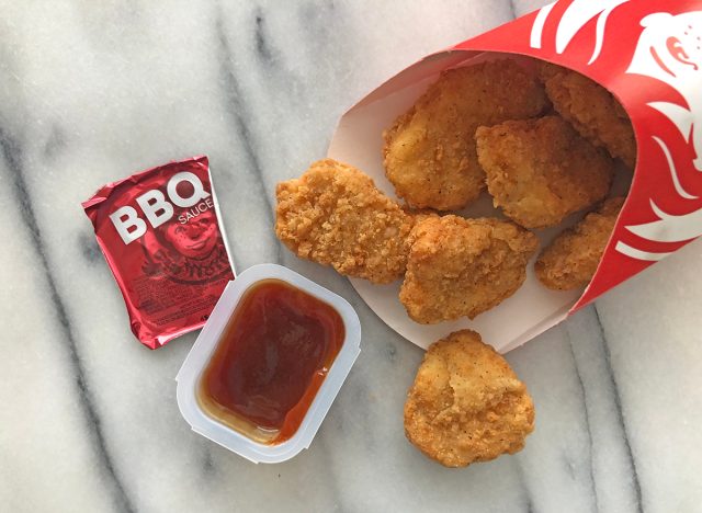 wendys bbq dipping sauce with nuggets spilled out on a table.