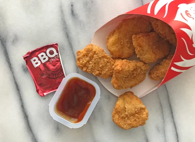 wendys bbq dipping sauce with nuggets spilled out on a table.