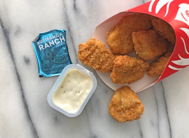 wendy's buttermilk ranch dipping sauce with nuggets spilled out on a table.