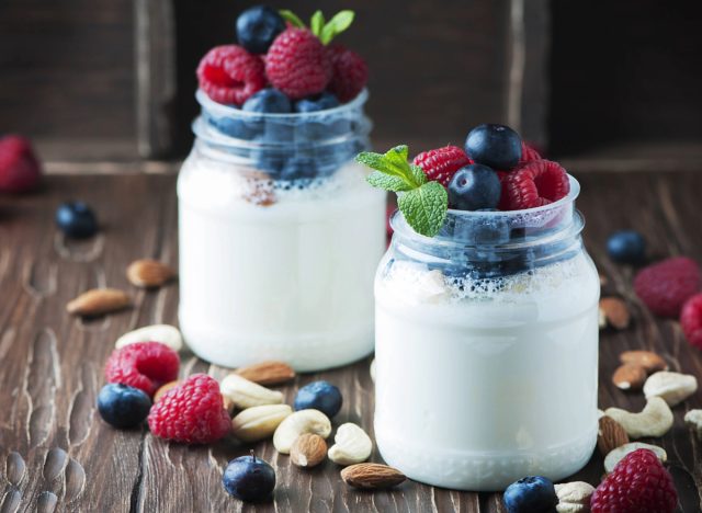 Greek yogurt parfait in mason jars with blueberries and raspberries and nuts