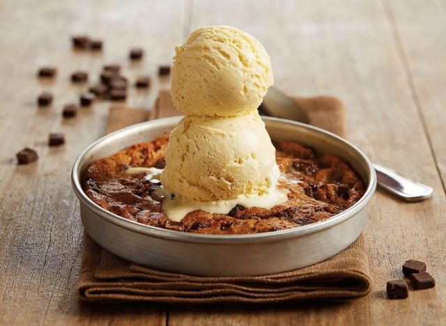 deep-dish pan with bj's chocolate chunk pizookie topped with vanilla ice cream