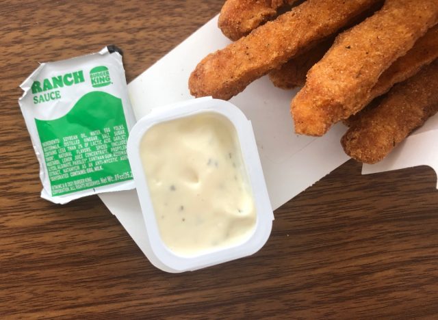 a packet of burger king ranch size with chicken fries on a table.