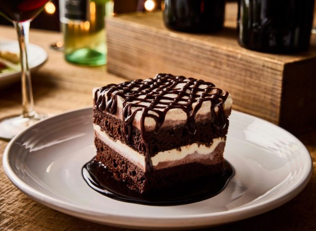 plate with carrabba's sogno di cioccolata (chocolate dream) cake next to a wine glass