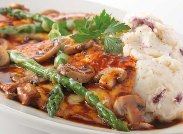 cheesecake factory's chicken madeira with asparagus, mushrooms, sauce, and a side of mashed potatoes