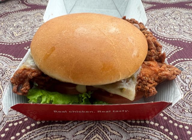 chick-fil-a spicy deluxe sandwich in a takeout container.