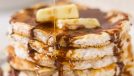 a stack of cinnamon cloud bread pancakes with syrup and butter